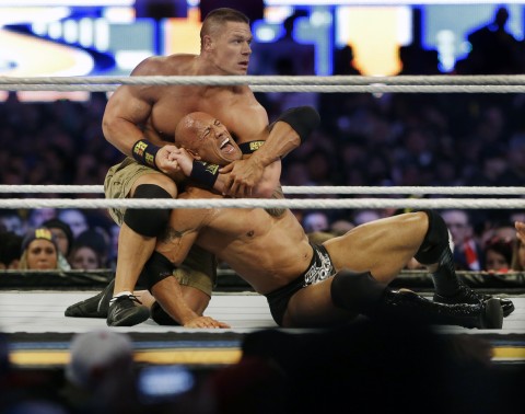 Wrestler John Cena, top, chokes Dwayne Douglas Johnson AP 2013