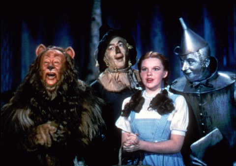 Bert Lahr as the Cowardly Lion, Ray Bolger as the Scarecrow, Judy Garland as Dorothy, and Jack Haley as the Tin Woodman, sing in this scene from "The Wizard of Oz." (AP Photo/HO,Warner Bros) 