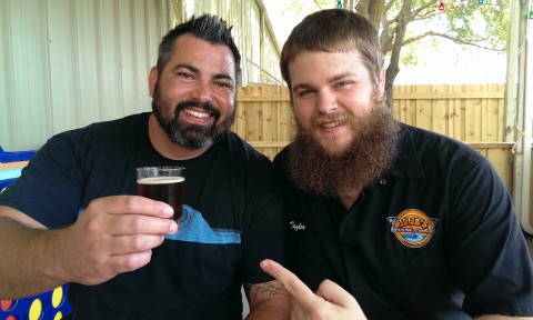  JDub's Brewing Co. CEO Jeremy Joerger (left) and beer tender/social media maven Taylor Pogue display a sample of Esperanza, a new collaboration with Drum Circle Distilling, the maker of Siesta Key Rum. STAFF PHOTO / WADE TATANGELO