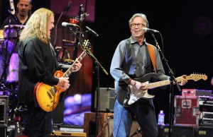 Musician Eric Clapton, right, joins Warren Haynes and The Allman Brothers Band on stage at Eric Clapton's Crossroads Guitar Festival 2013 at Madison Square Garden on Friday April 12, 2013 in New York. (Photo by Evan Agostini/Invision/AP)