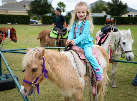 Natalie Meabon, 3, rode Alabama, one of the ponies from Roasire's Riding Academy at Lakewood Ranch Community Activities' second Festa Italiana Saturday, Nov. 16 at the Central Park Community. The event included entertainment, Italian food, pony rides, crafts and face painting. (November 16, 2013) (Herald-Tribune staff photo by Rachel S. O'Hara)  