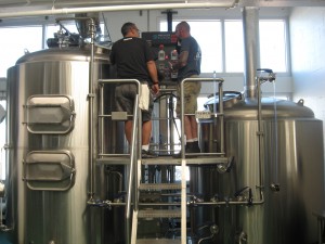 Darwin Brewing brewmaster Jorge Rosabal, left, works with Big Top Brewing brewmaster Josh Wilson on a collaboration brew at Darwin's brewery in Bradenton on Thursday, Nov. 13, 2014. (Staff photo / Alan Shaw)