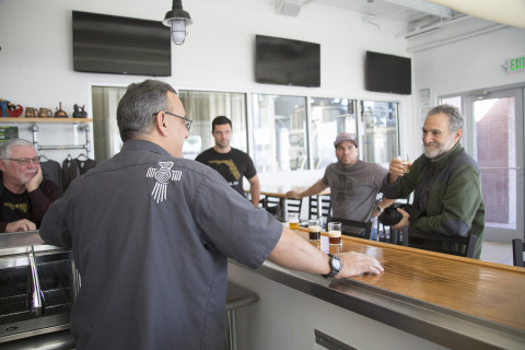 Charlie Papazian, right, samples some of the beers at Darwin Brewing Co. on Feb. 13 in Bradenton. (Photo by Karen Arango)
