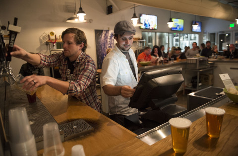Beertenders Scott Macy, left, and Tony Beam serve up craft beers in the taproom at the Darwin Brewery Company in Bradenton on Friday, February 6, 2015.     (Herald-Tribune staff photo by Nick Adams) CQ