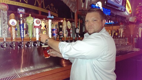Bartender James Wood pours a beer at Tavern on Main in downtown Sarasota. STAFF PHOTO / WADE TATANGELO  