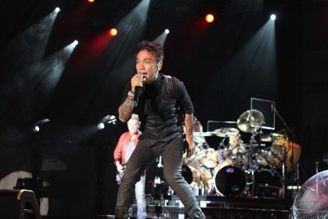Arnel Pineda of Journey performing as part of Music Midtown 2013 at Piedmont Park on Friday, September 20, 2013, in Atlanta. (Photo by Robb D. Cohen/Invision/AP)