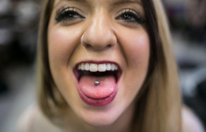 Nicole Coviello, 18, shows off her newly pierced tongue. (Staff photo / Nick Adams)