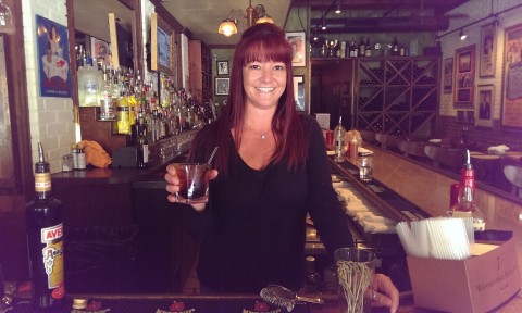 Bartender Kristina Iacofano poses with the "Lower Manhattan" cocktail she made at Caragiulos in downtown Sarasota. STAFF PHOTO / WADE TATANGELO