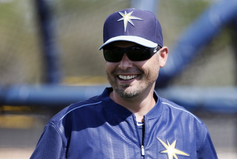 Tampa Bay Rays manager Kevin Cash smiles as he talks with members of his staff at baseball spring training in Port Charlotte, Fla., Monday March 2, 2015. (AP Photo/Tony Gutierrez) 
