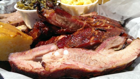 A half-rack of the long-bone, dry-rubbed and slow cooked Smokehouse Ribs, with mac-n-cheese, sweet collards greens with bacon ,and cornbread. (Staff photo by Wade Tatangelo)
