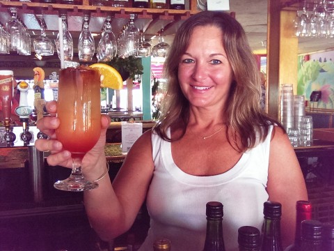 Bartender Kim O'Donnell poses with the "Horizons' beach ball" cocktail she made. (Staff photo by Wade Tatangelo)