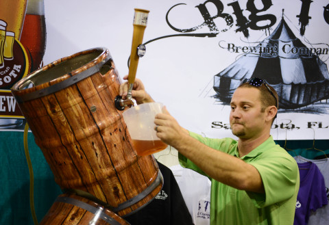 Mike Bisaha pours beer from Big Top's fun tap at The Sarasota Craft Brew Fest in 2014. STAFF PHOTO / RACHEL S. O'HARA