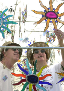 (03-10-02)(Staff photo by Michael Diemer, Sarasota Herald-Tribune) Forrest and Connie Wisely look at stained glass designs at the Yolie & Me booth at Springfest in Holmes Beach Sunday.  The annual event sponsored by the Anna Maria Island Art League attracts artist and craftspeople to Holmes Beach City Park to display their creations.