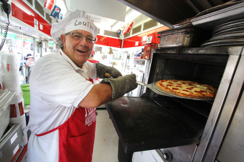 Lou Piazza cooks pizzas for carnival goers at the 25th Annual Venice Italian Feast and Carnival. The festival continues this weekend at the Venice Municipal Airport. The event is sponsored by the Italian American Club of Venice and features traditional Italian meals, entertainment, carnival rides and midway games. The event runs through Sunday with four dollar parking and free admission.  ( Photo/ Matt Houston )