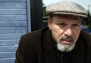 Pulitzer Prize-winning playwright August Wilson poses during a visit to a coffee shop Friday, May 30, 2003, in his Seattle neighborhood. After more than two decades in theater, Wilson finally has the acting bug, making his stage debut two weeks ago in his autobiographical monologue, "How I Learned What I Learned," and he will make his movie debut this month as narrator of "The Naked Proof," an independent film premiering at the Seattle International Film Festival. (AP Photo/Ted S. Warren)