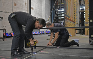 Armando Cristiani, left, and Benni Fornasari secure tracks on the stage that help move the big main pieces of the set for "Aida" into place at the Sarasota Opera House.  (March 05, 2016; STAFF  PHOTO / THOMAS BENDER)