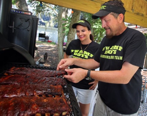 Rob and Amy Bagby , who are part of the Swamp Boys BBQ Team prepare barbeque ribs at their home in Winter Haven Fl. Wednesday June 26, 2013. Winter Haven Their BBQ team will be featured on the show BBQ Pitmasters on Destination America. Ernst Peters/The Ledger.  Winter Haven BBQ team will be featured on the show BBQ Pitmasters on Destination America.