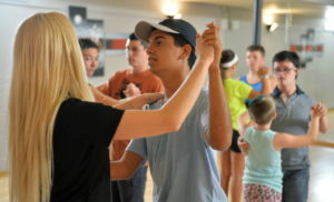 Jordan Soriano holds a proper dance frame while rehearsing with Dynasty Dance Club instructor Sarah Haworth, who started the class for special needs students in January. STAFF PHOTO / MIKE LANG