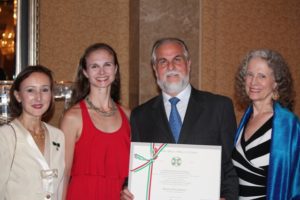 Victor DeRenzi, center, artistic director of Sarsaota Opera, was knighted by the Italian government during a ceremony with Dr. Gloria Marina Bellelli, Italian Consul General in Miami, left, his daughter, Francesca MacBeth, and his wife Stephanie Sundine. PHOTO PROVIDED BY SARASOTA OPERA