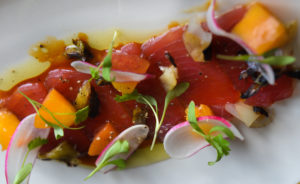 Yellowfin tuna crudo with pickled peaches and charred scallions at Veronica. (STAFF PHOTO / DAN WAGNER)