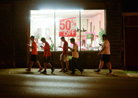 A group of teenagers play "Pokemon Go" in downtown Hartselle, Ala., on Wednesday, July 13, 2016. (Crystal VanderWeit/The Decatur Daily via AP)