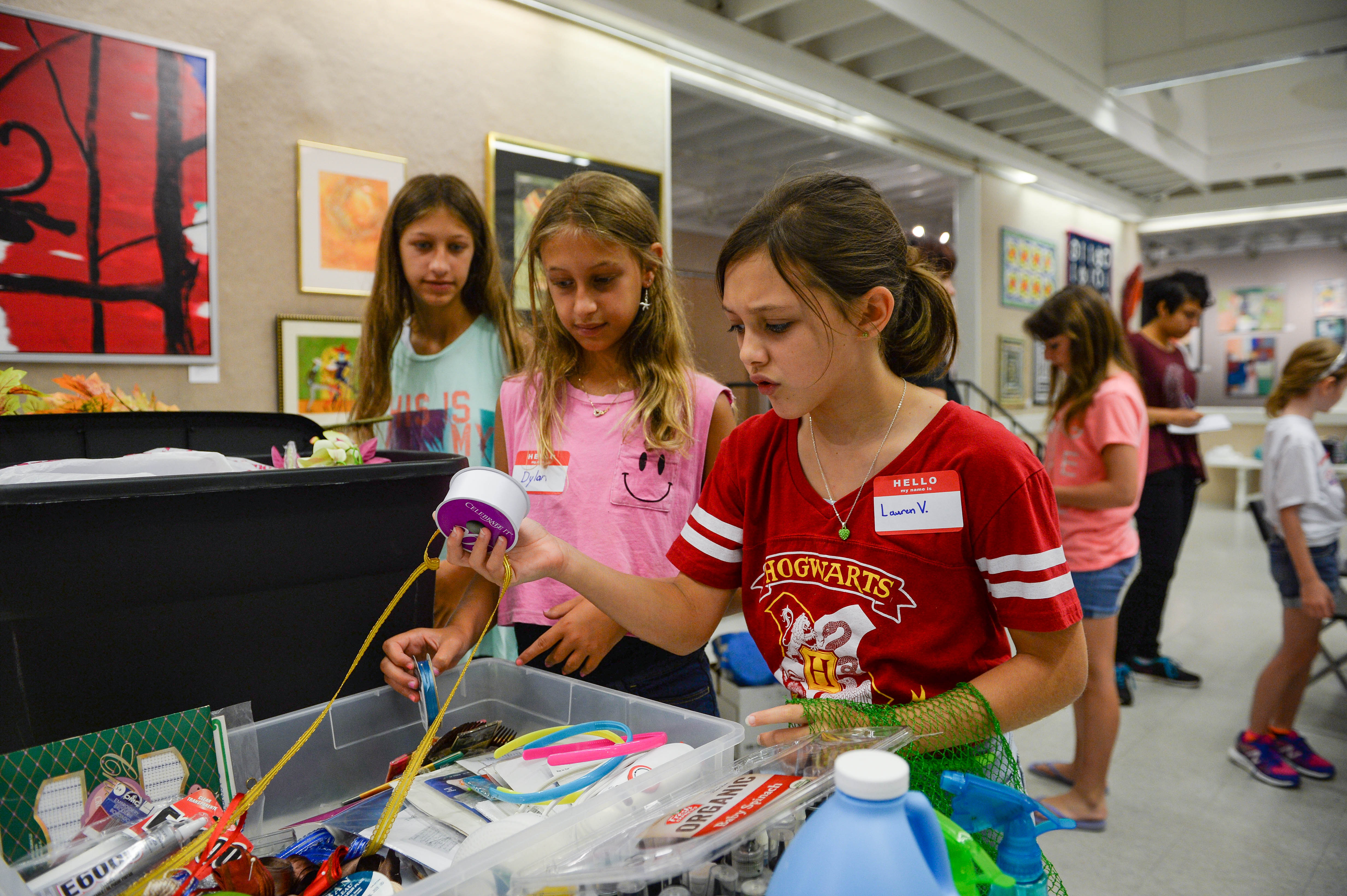 Madison Bierig, 14, Dylan Bierig, 11, and Lauren Van Nostrand, 11, look through boxes filled with a variety of supplies Monday, July 25 during Art Center Sarasota's iConcept Jr. summer camp. STAFF PHOTO / RACHEL S. O'HARA