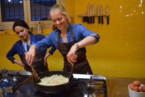 University of Florida PhD student Nicki Karimipour and undergraduate student Lauren Hemingway tossed potatoes and onions in a skillet to be cooked into an egg omelet called tortilla de patatas. PHOTO BY DARCY SCHILD.