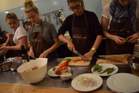 University of Florida students Victoria Price, left, Lena Fucile, Christine Anez and Victoria Najmy cut up vegetables to be used in a chicken paella in a coooking class in Barcelona. PHOTO PROVIDED DARCY SCHILD